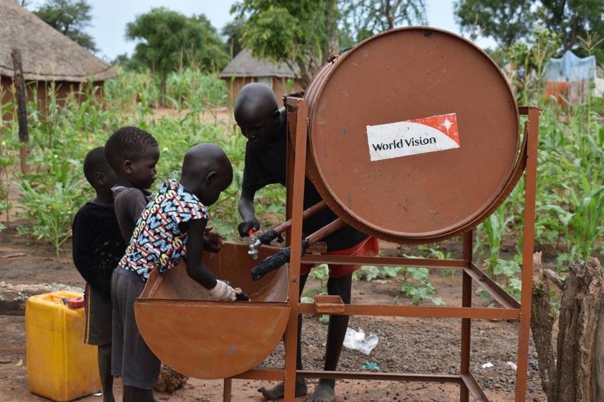 Yar teaches her siblings’ the proper way to wash their hands using facilities given by World Vision’s water, sanitation and hygiene program. (South Sudan, 2022)