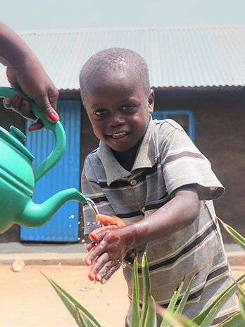 A boy is washing his hands practicing good hygiene to prevent diseases. (South Sudan, 2021)