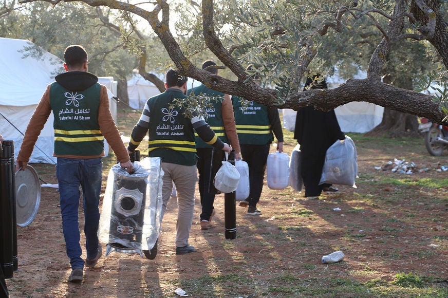 A group of staff from World Vision’s partner Takaful al Sham distributing non-food items like heaters and fuel to people affected by the earthquake. (Syria, 2023).