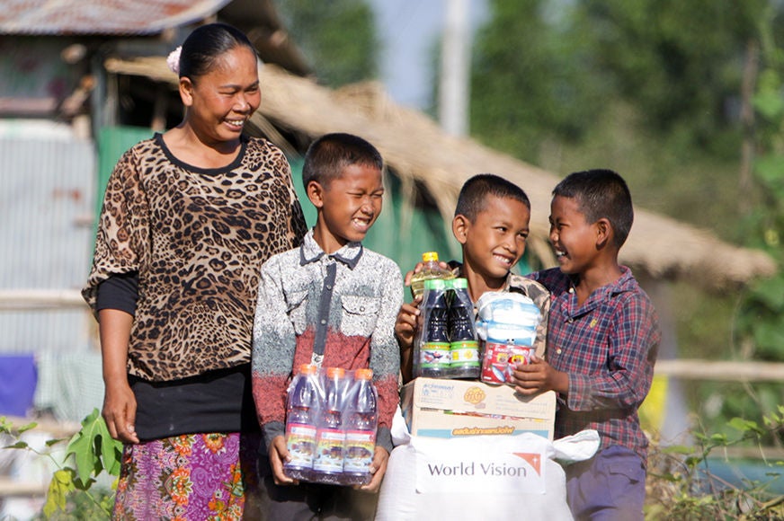 A mother and her three sons received a food basket provided by World Vision in Cambodia. (Cambodia, 2020)