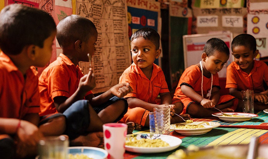 Preschoolers enjoy a nourishing meal at school, thanks to World Vision’s Learning Roots program, which offers mothers a chance practice nutritional cooking. (Bangladesh, 2023)