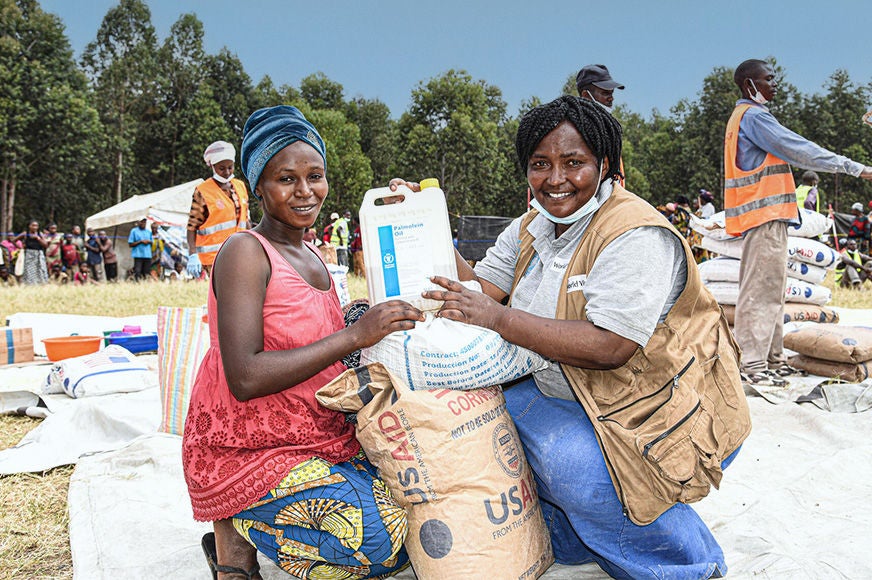 A woman receives emergency relief goods from World Vision and the World Food Programme.