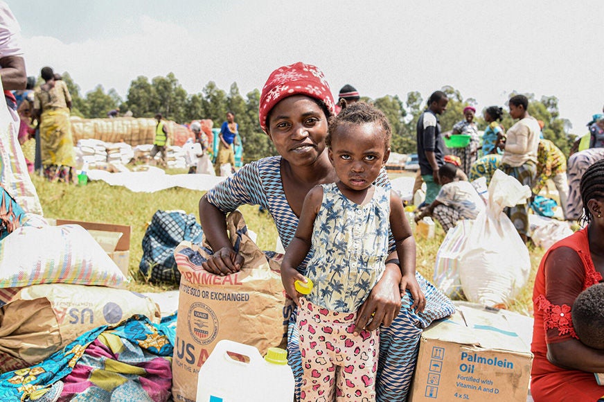 A mother and her child received food during a relief distribution in North Kivu, Democratic Republic of Congo. (Democratic Republic of Congo, 2023)