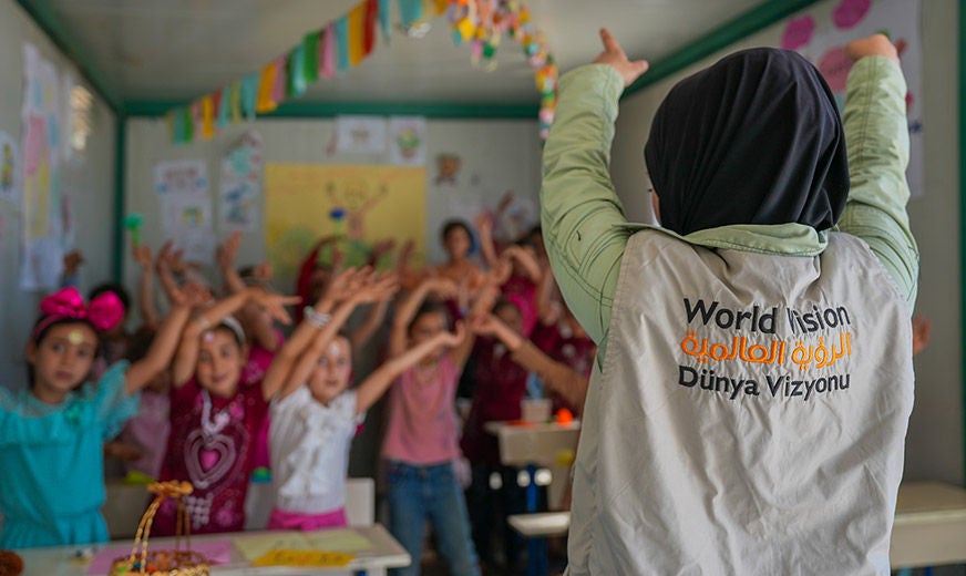 A World Vision staff leads a group of children in educational activities, in partnership with the Syria Cross-border Humanitarian Fund. (Syria, 2023)