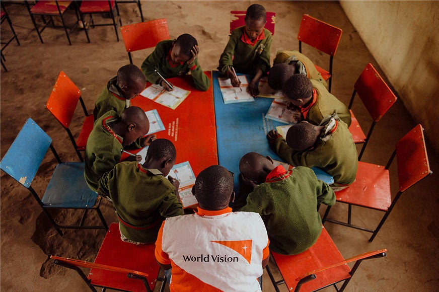 A group of sponsored children write letters to their sponsors in Osiligi, where World Vision has focused on strengthening education and girls' rights since 2006. (Kenya, 2023) 