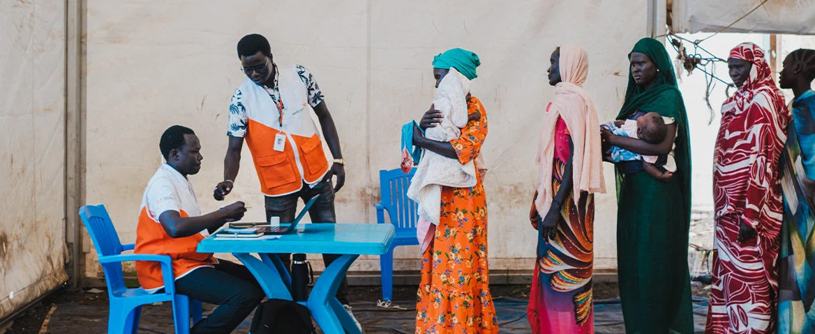 Group of women line up to receive a cash transfer. (South Sudan, 2024)
