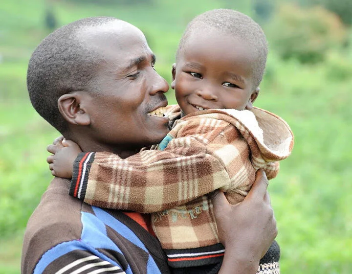 A father holding a child.