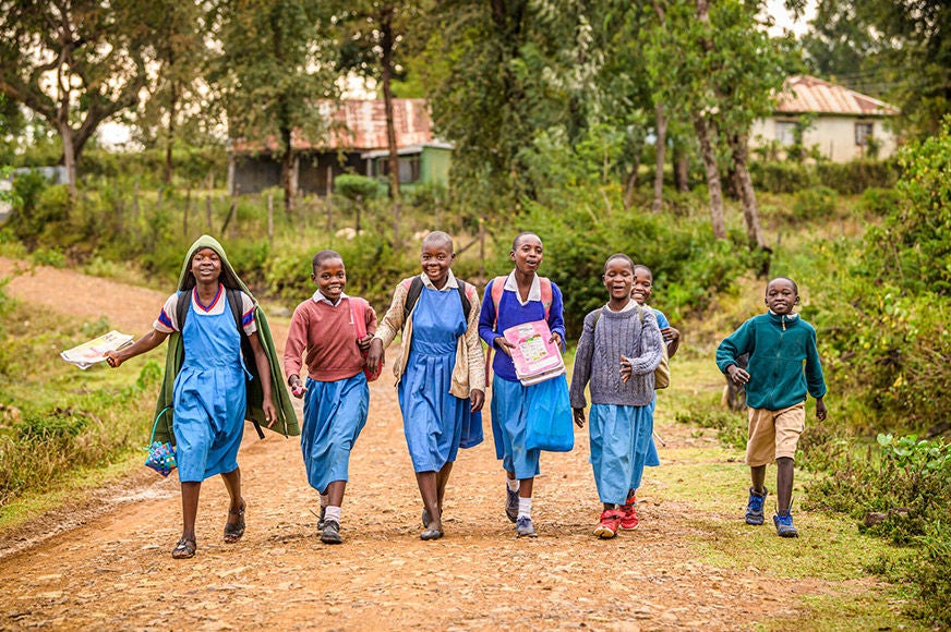 A group of students head home after class in Katito, a community that recently reached self-suffiency after two decades of partnership with World Vision. (Kenya, 2022)