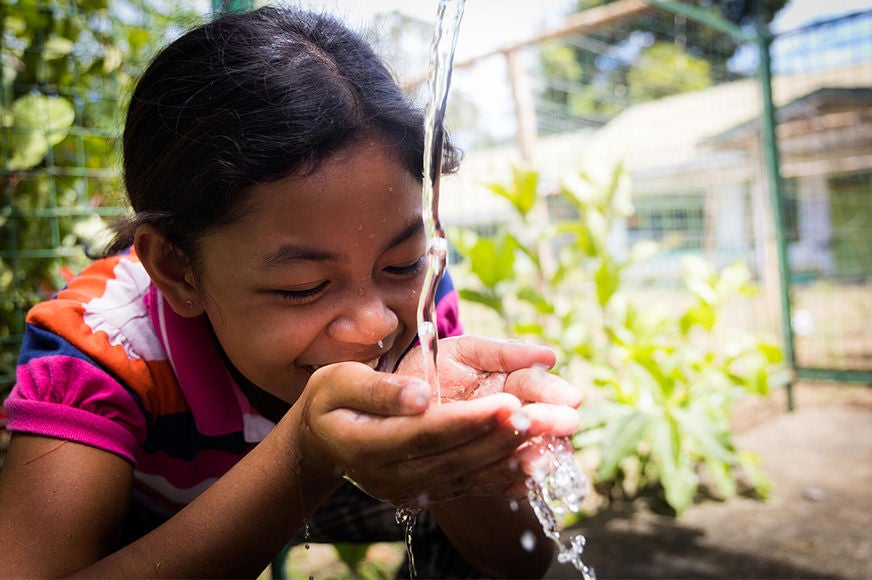 A girl drinks from the school water fountain, which was installed by World Vision and local community members. (Philippines, 2022)